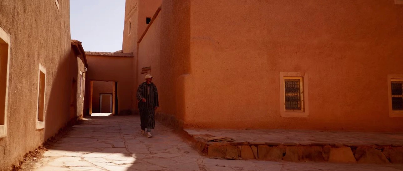 A man walking down an orange street