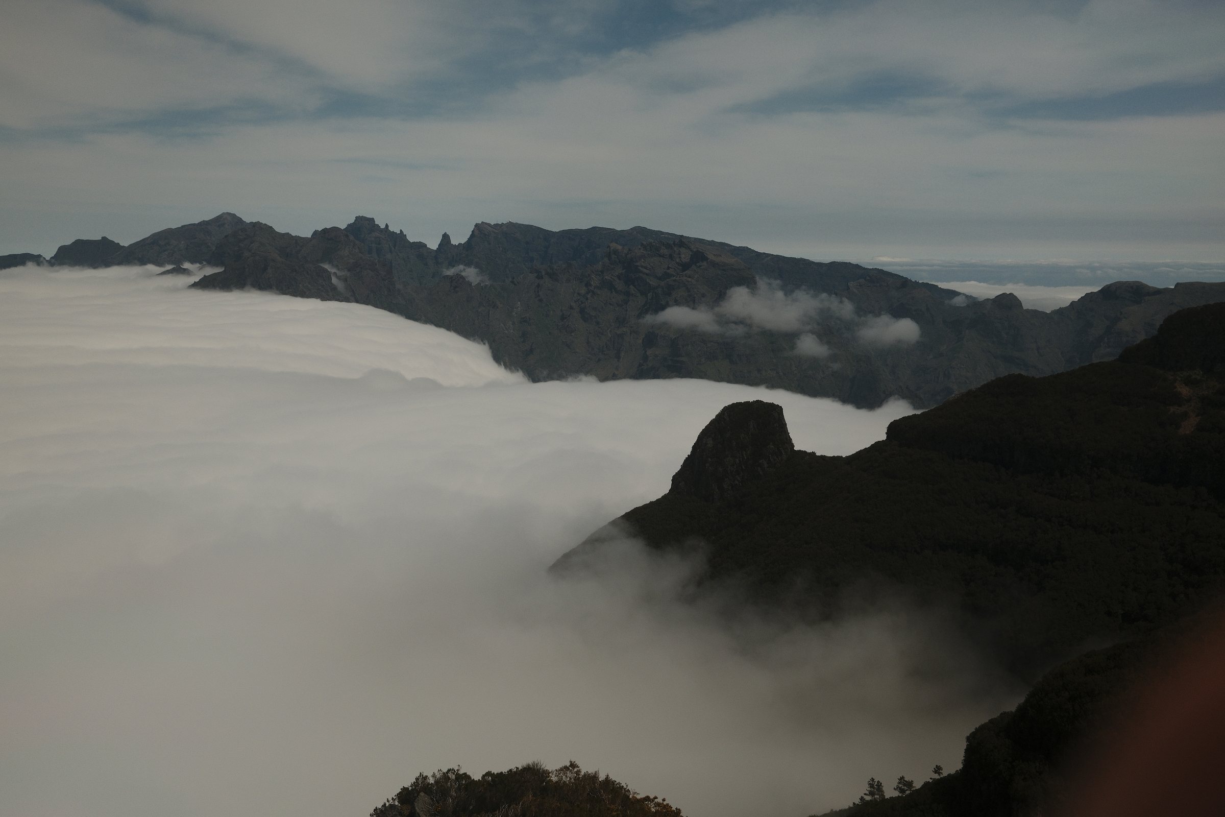 Sea of clouds below jagged ridges
